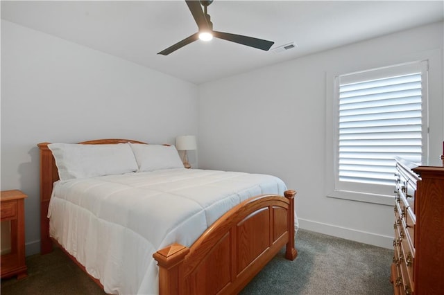bedroom with dark colored carpet, baseboards, and ceiling fan