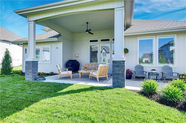 rear view of property featuring a ceiling fan, roof with shingles, a lawn, and a patio area