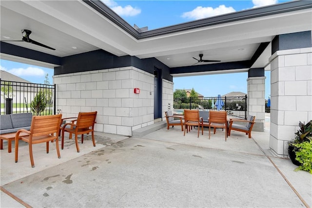 view of patio featuring outdoor dining space, fence, and a ceiling fan