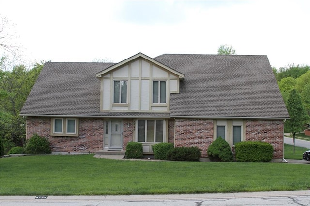 6726 Mill Creek Rd, Shawnee, KS 66217 - tudor house with a front yard, roof with shingles, and brick siding
