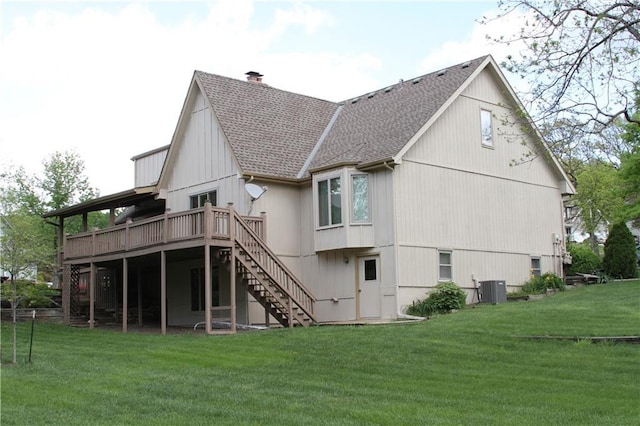 6726 Mill Creek Rd, Shawnee, KS 66217 - back of property featuring a shingled roof, a wooden deck, stairs, a lawn, and a chimney