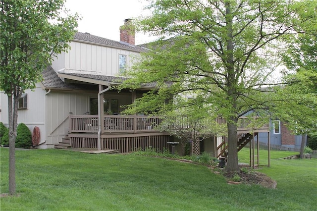 6726 Mill Creek Rd, Shawnee, KS 66217 - rear view of property with stairway, a chimney, a deck, roof with shingles, and a lawn