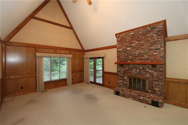 6726 Mill Creek Rd, Shawnee, KS 66217 - unfurnished living room featuring a fireplace, carpet floors, wooden walls, high vaulted ceiling, and a wainscoted wall