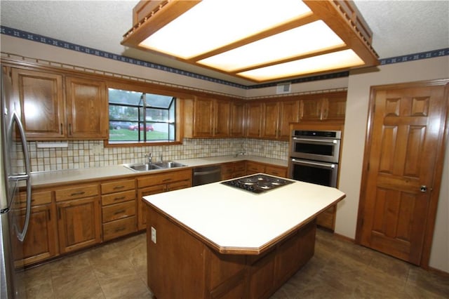 6726 Mill Creek Rd, Shawnee, KS 66217 - kitchen featuring a sink, stainless steel appliances, brown cabinets, a textured ceiling, and tasteful backsplash