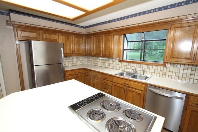 6726 Mill Creek Rd, Shawnee, KS 66217 - kitchen with appliances with stainless steel finishes, a sink, brown cabinetry, and light countertops