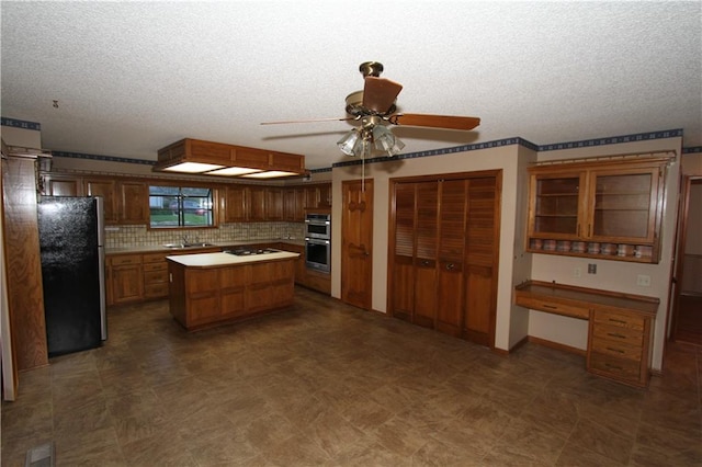 6726 Mill Creek Rd, Shawnee, KS 66217 - kitchen with appliances with stainless steel finishes, a sink, ceiling fan, a textured ceiling, and a center island