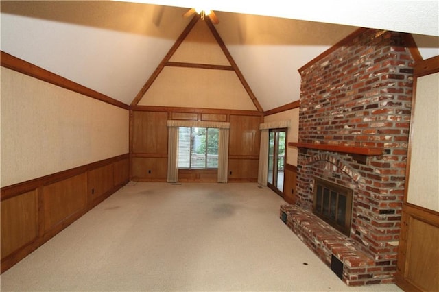 6726 Mill Creek Rd, Shawnee, KS 66217 - unfurnished living room featuring a brick fireplace, a wainscoted wall, wooden walls, vaulted ceiling, and light carpet
