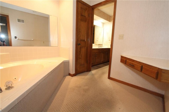 6726 Mill Creek Rd, Shawnee, KS 66217 - bathroom with a jetted tub, vanity, and baseboards