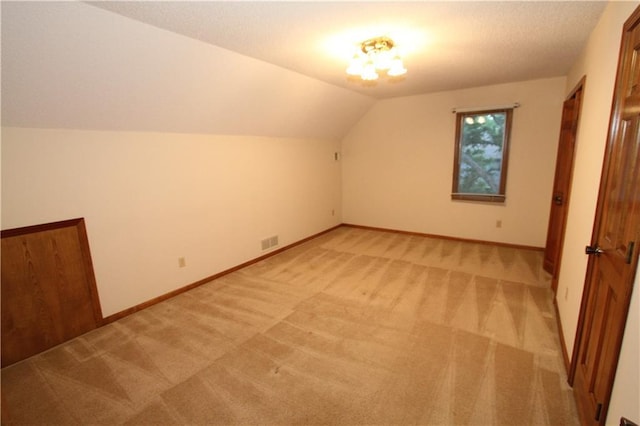6726 Mill Creek Rd, Shawnee, KS 66217 - additional living space featuring light colored carpet, vaulted ceiling, and baseboards