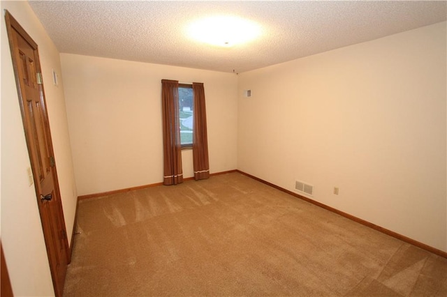 6726 Mill Creek Rd, Shawnee, KS 66217 - unfurnished room featuring light colored carpet, baseboards, and a textured ceiling