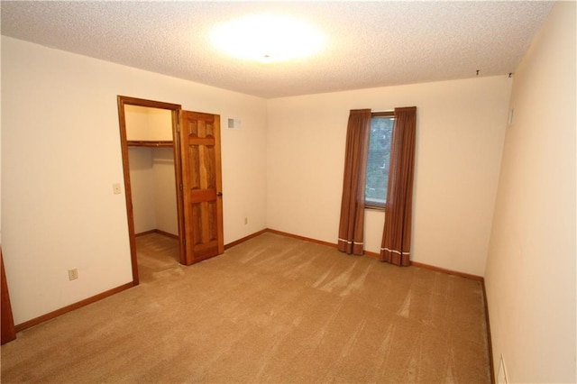 6726 Mill Creek Rd, Shawnee, KS 66217 - unfurnished bedroom featuring light colored carpet, a closet, a spacious closet, a textured ceiling, and baseboards