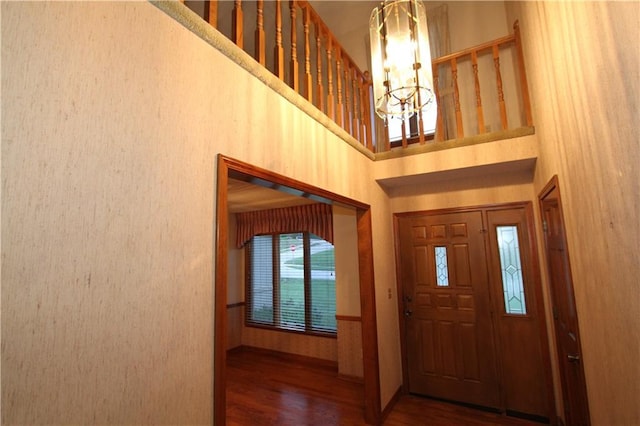 6726 Mill Creek Rd, Shawnee, KS 66217 - foyer entrance featuring a chandelier, a high ceiling, wood finished floors, and baseboards
