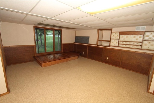 6726 Mill Creek Rd, Shawnee, KS 66217 - basement featuring a paneled ceiling, a wainscoted wall, and wood walls