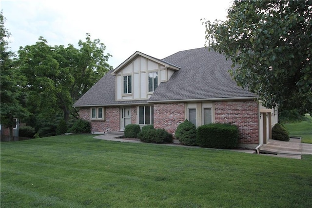 6726 Mill Creek Rd, Shawnee, KS 66217 - tudor-style house with a front yard, brick siding, a garage, and roof with shingles