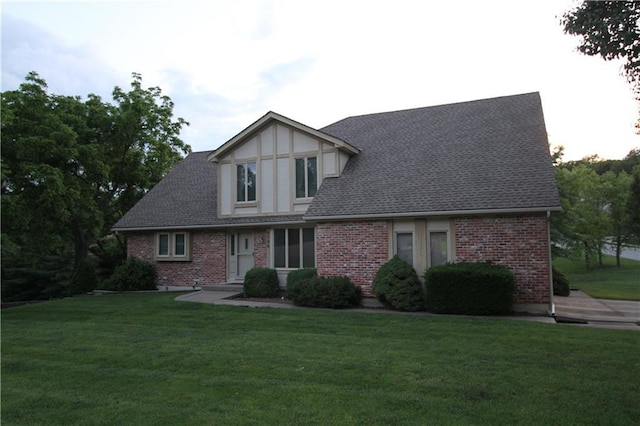 6726 Mill Creek Rd, Shawnee, KS 66217 - tudor home with a front lawn, brick siding, and roof with shingles