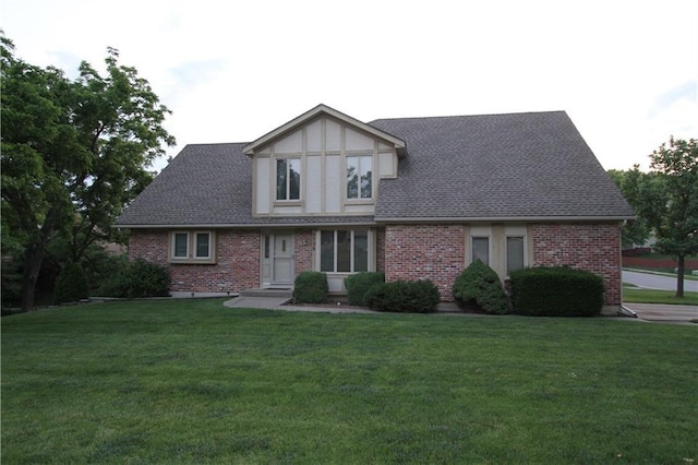 6726 Mill Creek Rd, Shawnee, KS 66217 - tudor home with a front yard, brick siding, and roof with shingles