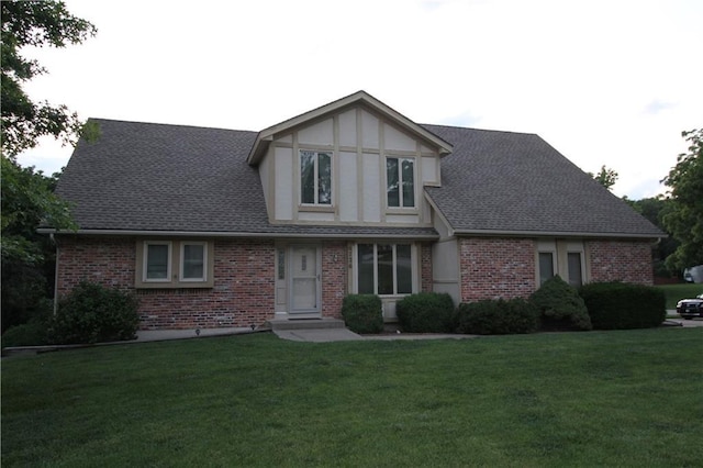 6726 Mill Creek Rd, Shawnee, KS 66217 - english style home featuring brick siding, a front lawn, and a shingled roof