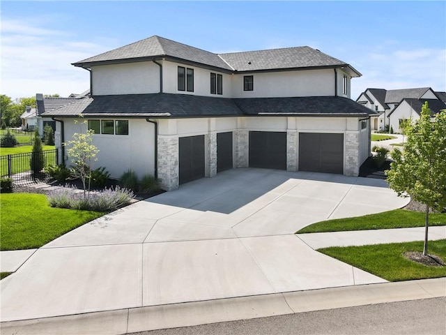 11201 W 169th St, Overland Park, KS 66221 - view of front of home with a garage, driveway, stone siding, and stucco siding