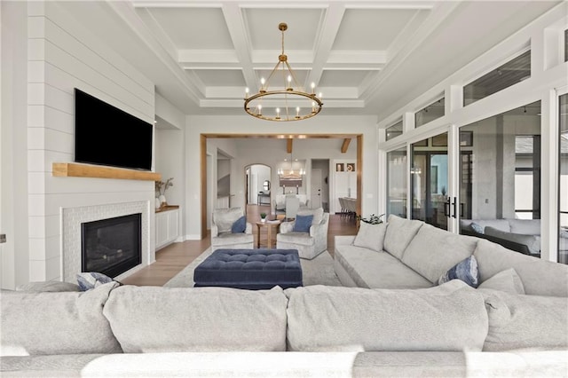11201 W 169th St, Overland Park, KS 66221 - living room featuring a chandelier, wood finished floors, coffered ceiling, a large fireplace, and beam ceiling
