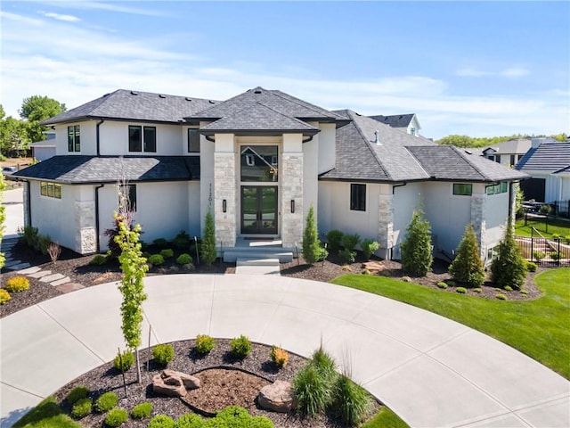11201 W 169th St, Overland Park, KS 66221 - view of front of home featuring stone siding, stucco siding, curved driveway, and french doors