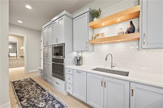 11201 W 169th St, Overland Park, KS 66221 - kitchen with stainless steel appliances, a sink, gray cabinets, decorative backsplash, and recessed lighting