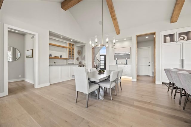 11201 W 169th St, Overland Park, KS 66221 - dining space featuring beam ceiling, a chandelier, light wood-type flooring, stairway, and baseboards