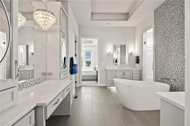 11201 W 169th St, Overland Park, KS 66221 - full bath featuring ensuite bath, a freestanding tub, tile patterned flooring, and vanity