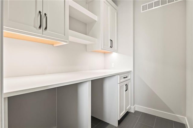 11201 W 169th St, Overland Park, KS 66221 - kitchen featuring white cabinets, open shelves, light countertops, baseboards, and dark tile patterned floors