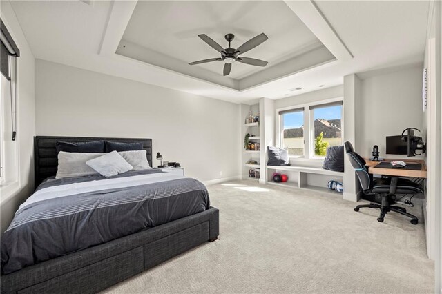11201 W 169th St, Overland Park, KS 66221 - carpeted bedroom featuring a tray ceiling, an office area, baseboards, and a ceiling fan