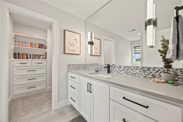 11201 W 169th St, Overland Park, KS 66221 - bathroom with vanity, backsplash, and baseboards