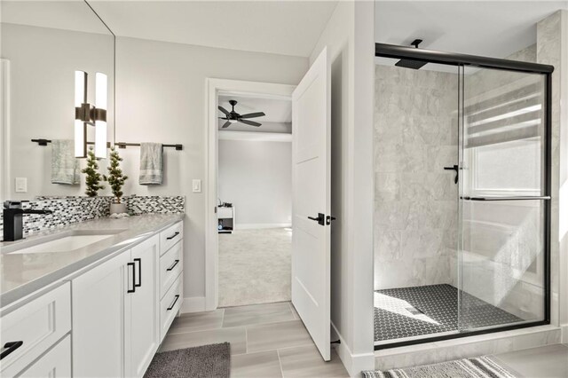11201 W 169th St, Overland Park, KS 66221 - full bath featuring vanity, a stall shower, a ceiling fan, and baseboards