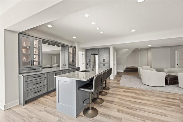11201 W 169th St, Overland Park, KS 66221 - kitchen featuring gray cabinets, freestanding refrigerator, a sink, light wood-style flooring, and recessed lighting