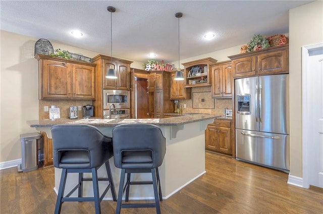 3536 SW Dana Ave E, Lees Summit, MO 64082 - kitchen with stainless steel appliances, a breakfast bar area, open shelves, tasteful backsplash, and hanging light fixtures