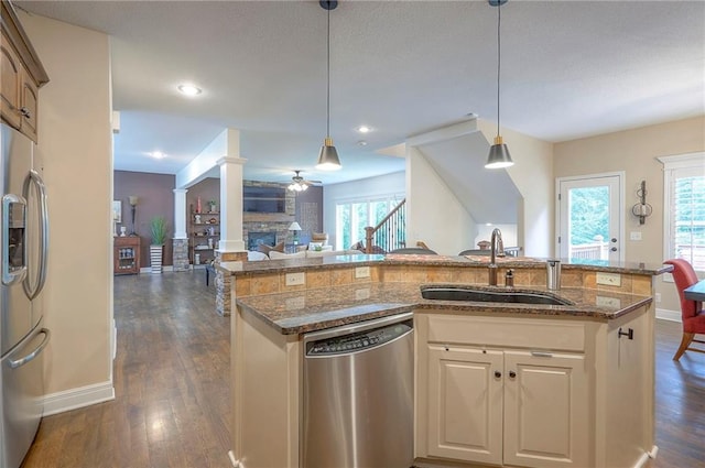 3536 SW Dana Ave E, Lees Summit, MO 64082 - kitchen with stainless steel appliances, a sink, open floor plan, a center island with sink, and dark stone counters
