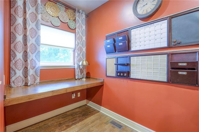3536 SW Dana Ave E, Lees Summit, MO 64082 - unfurnished office with built in desk, wood finished floors, and baseboards