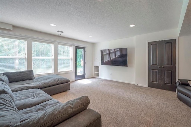 3536 SW Dana Ave E, Lees Summit, MO 64082 - living area with carpet flooring, a textured ceiling, recessed lighting, and baseboards