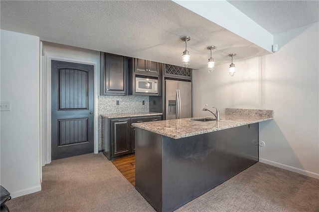 3536 SW Dana Ave E, Lees Summit, MO 64082 - kitchen featuring stainless steel fridge with ice dispenser, white microwave, a sink, a peninsula, and a breakfast bar