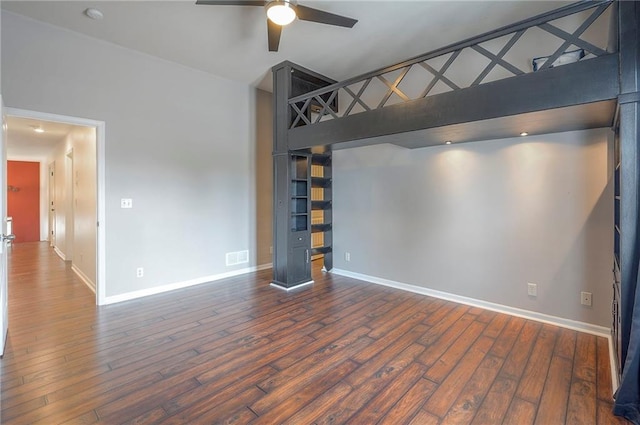 3536 SW Dana Ave E, Lees Summit, MO 64082 - unfurnished bedroom featuring baseboards, wood finished floors, and a towering ceiling