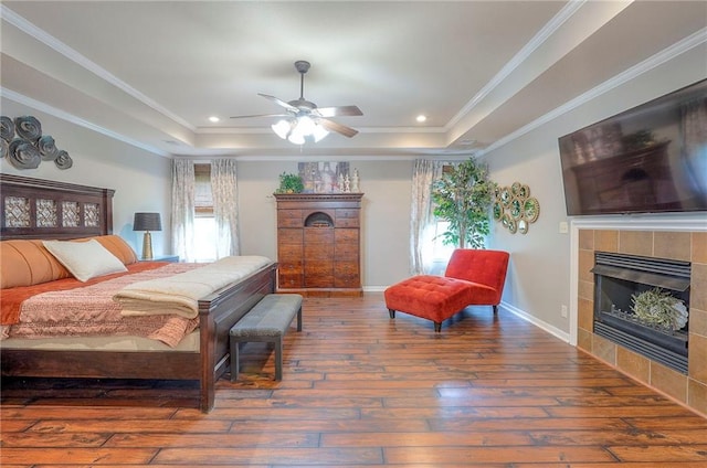 3536 SW Dana Ave E, Lees Summit, MO 64082 - bedroom with a raised ceiling, hardwood / wood-style floors, a fireplace, multiple windows, and crown molding