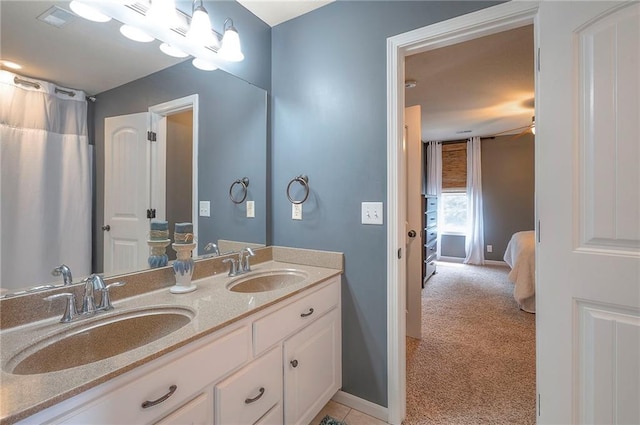 3536 SW Dana Ave E, Lees Summit, MO 64082 - bathroom featuring double vanity, ensuite bathroom, and baseboards
