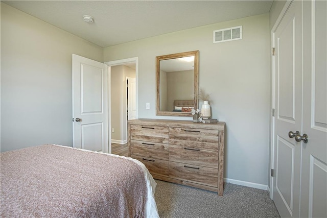 bedroom featuring visible vents, baseboards, and carpet floors