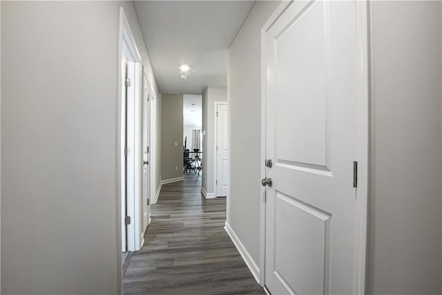 hall with baseboards and dark wood-style floors