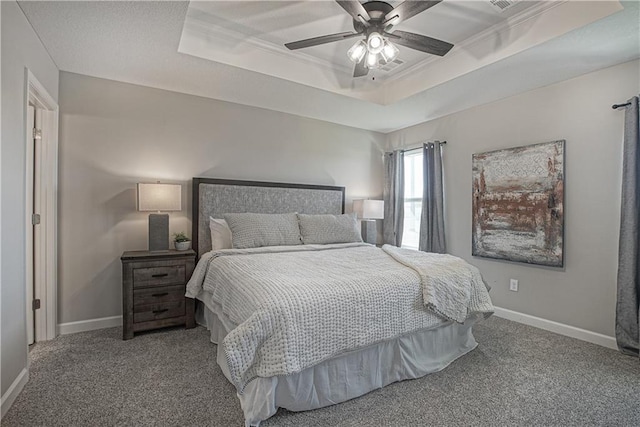 bedroom featuring carpet flooring, baseboards, ceiling fan, and a raised ceiling