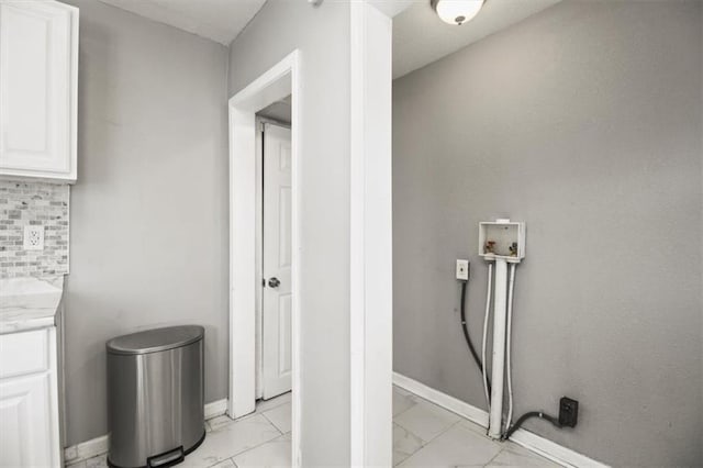 6101 Swope Pkwy, Kansas City, MO 64130 - laundry room with light marble finish flooring and washer hookup