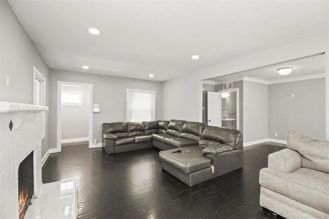 6101 Swope Pkwy, Kansas City, MO 64130 - living area with wood finished floors, a fireplace, recessed lighting, and crown molding