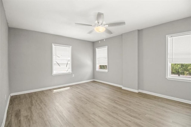 6101 Swope Pkwy, Kansas City, MO 64130 - spare room featuring wood finished floors and a ceiling fan