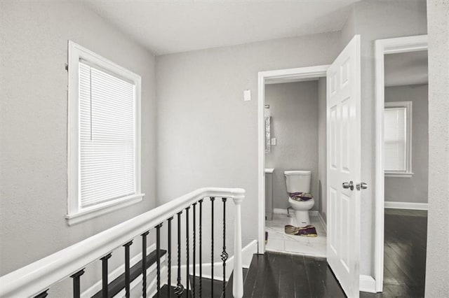 6101 Swope Pkwy, Kansas City, MO 64130 - corridor featuring wood finished floors and an upstairs landing