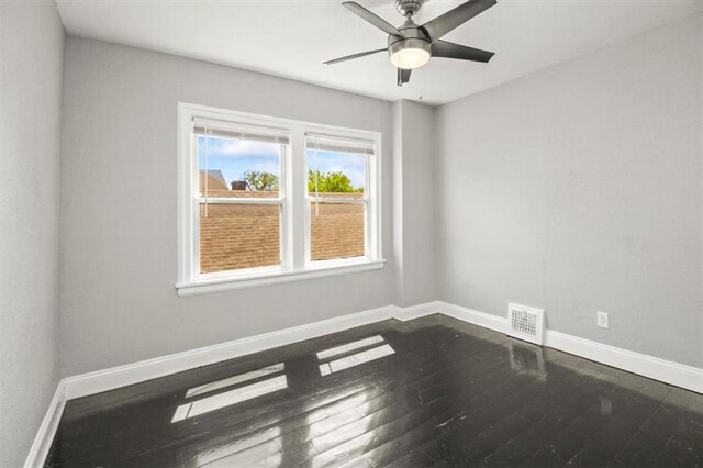 6101 Swope Pkwy, Kansas City, MO 64130 - empty room with dark wood-type flooring and ceiling fan