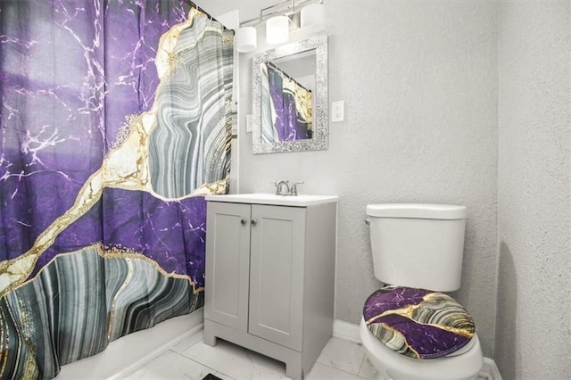6101 Swope Pkwy, Kansas City, MO 64130 - bathroom featuring marble look tiles, vanity, and a textured wall