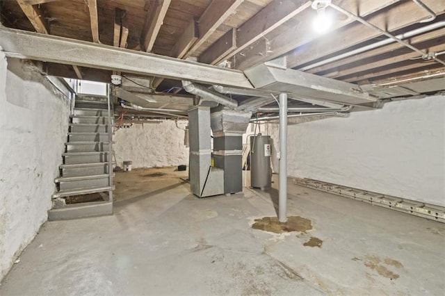 6101 Swope Pkwy, Kansas City, MO 64130 - unfinished basement with water heater, heating unit, and stairway
